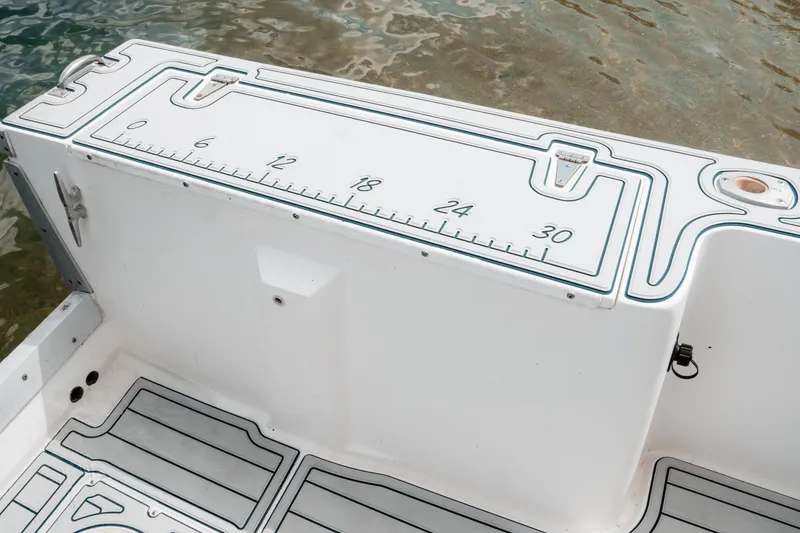 Slide: The Image of 1996 Mako 231 Center Console boat with measuring ruler on deck. - 36