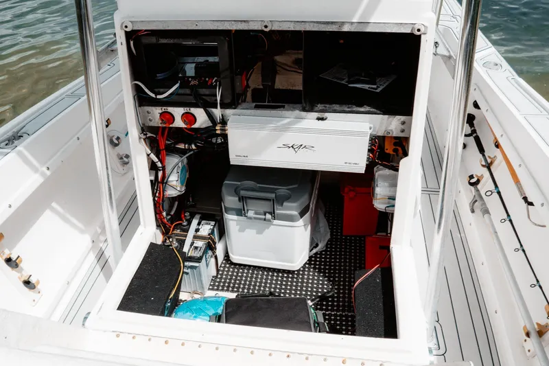 Slide: The Image of Open console of a 1996 Mako 231 Center Console boat, showing wiring and equipment. - 46