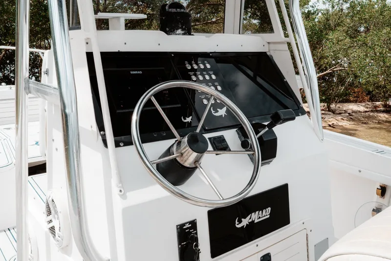 Slide: The Image of 1996 Mako 231 Center Console boat steering wheel and control panel. - 6