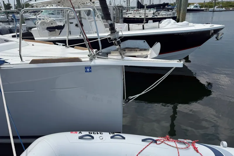 Slide: The Image of 2022 Jeanneau Sun Odyssey 349 Performance yacht docked at marina with inflatable boat. - 16