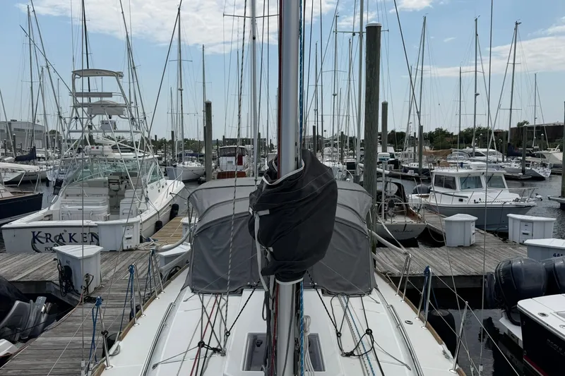 Slide: The Image of 2022 Jeanneau Sun Odyssey 349 Performance yacht docked in a busy marina. - 28