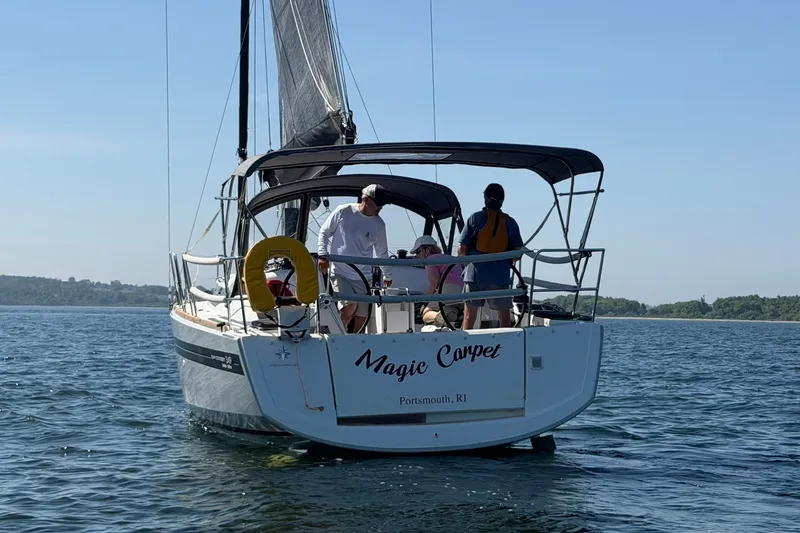 Slide: The Image of 2022 Jeanneau Sun Odyssey 349 Performance sailboat on water, named "Magic Carpet." - 10