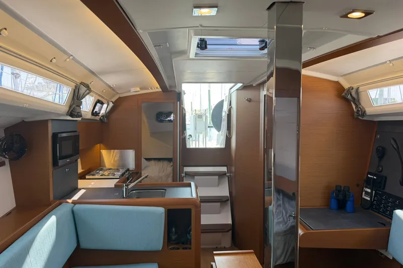 Slide: The Image of Interior of 2022 Jeanneau Sun Odyssey 349 Performance yacht, featuring modern kitchen and seating area. - 43
