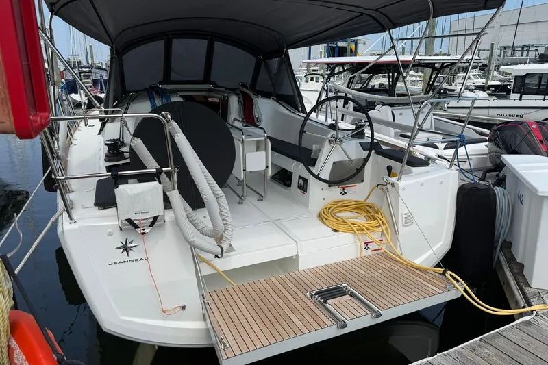 Slide: The Image of 2022 Jeanneau Sun Odyssey 349 Performance yacht docked at marina, showcasing cockpit and helm. - 3