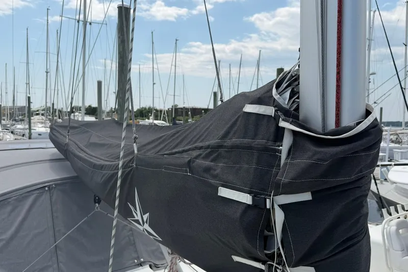 Slide: The Image of Jeanneau Sun Odyssey 349 Performance 2022 sailboat mast and sail cover at marina. - 29