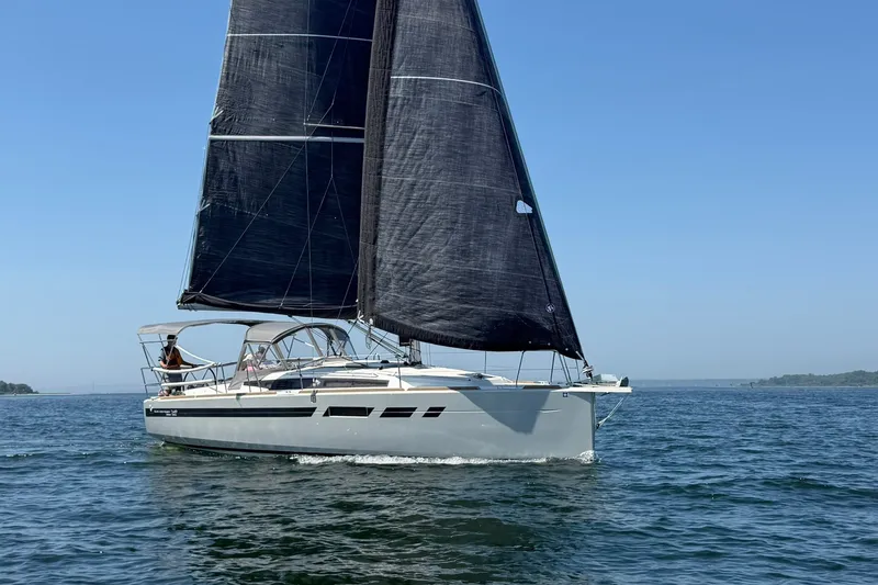 Slide: The Image of 2022 Jeanneau Sun Odyssey 349 Performance sailing on open water under clear blue skies. - 13