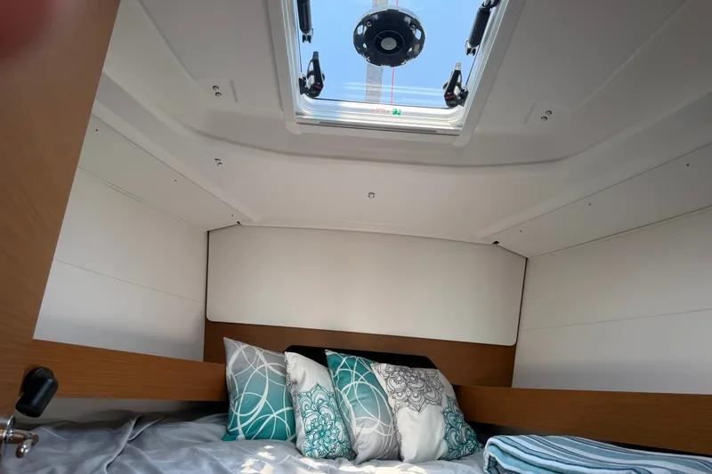 Slide: The Image of Cozy cabin interior of 2022 Jeanneau Sun Odyssey 349 Performance sailboat with skylight and pillows. - 46