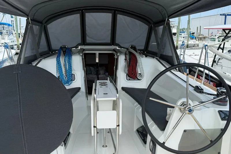 Slide: The Image of 2022 Jeanneau Sun Odyssey 349 Performance cockpit with steering wheel and ropes, docked at marina. - 7