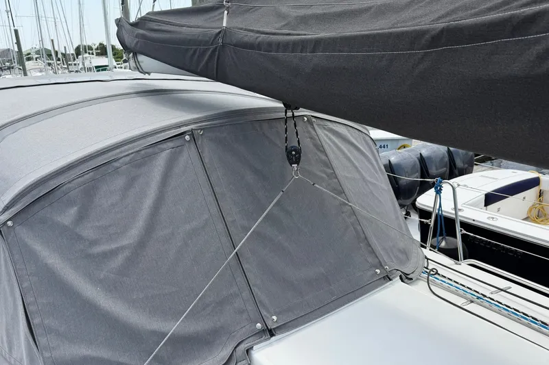 Slide: The Image of Jeanneau Sun Odyssey 349 Performance 2022 sailboat with gray canvas cover in marina. - 18
