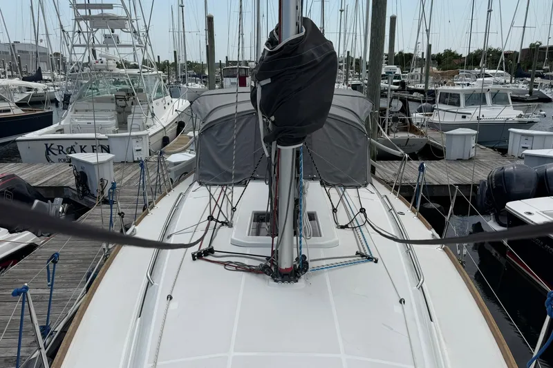 Slide: The Image of 2022 Jeanneau Sun Odyssey 349 Performance sailboat docked at marina, showcasing deck and rigging. - 17