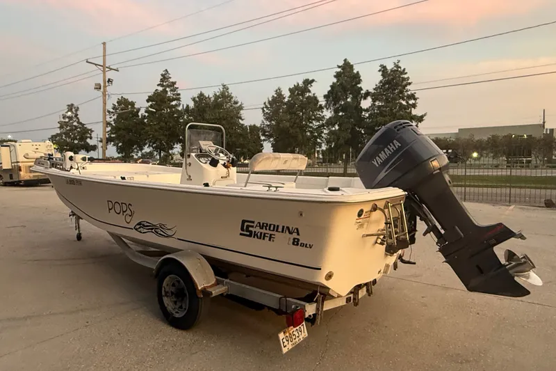 Slide: The Image of 2011 Carolina Skiff 218 DLV boat with Yamaha outboard motor on trailer at sunset. - 5
