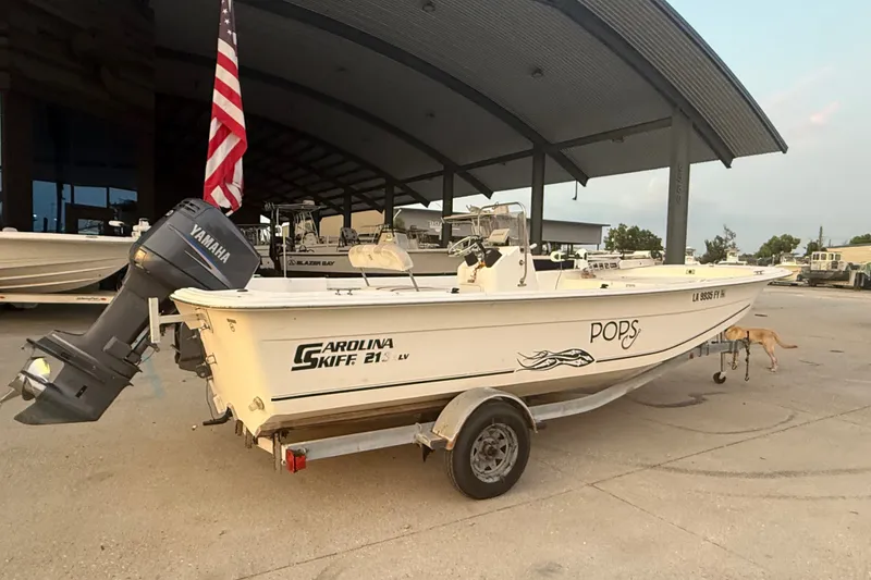 Slide: The Image of 2011 Carolina Skiff 218 DLV boat on trailer with Yamaha outboard motor. - 3
