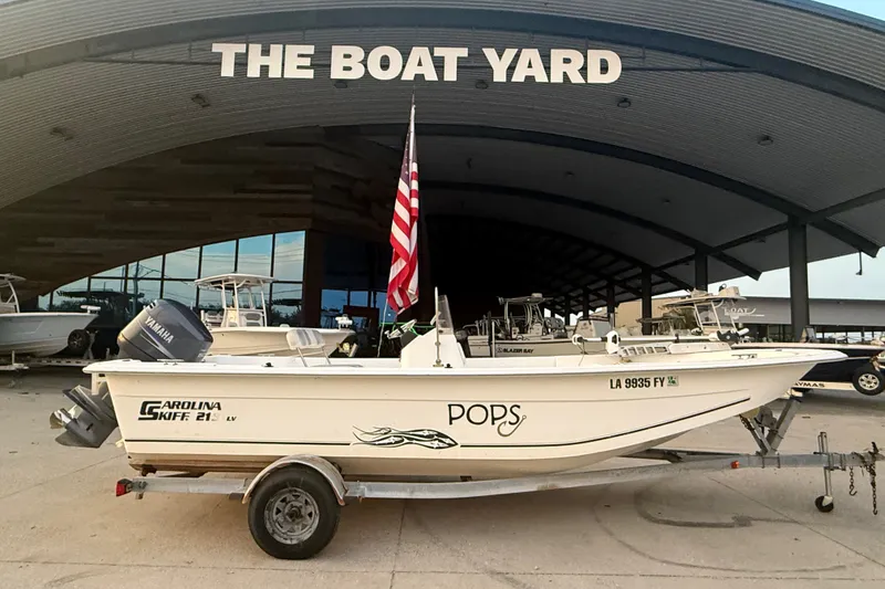 Slide: The Image of 2011 Carolina Skiff 218 DLV boat on trailer at The Boat Yard dealership. - 1