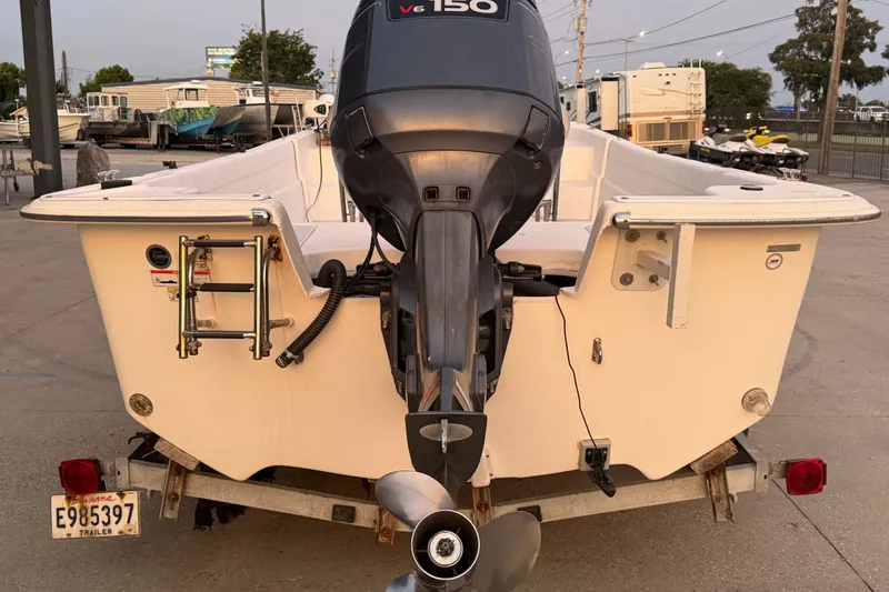 Slide: The Image of 2011 Carolina Skiff 218 DLV boat with V6 150 engine on trailer. - 4