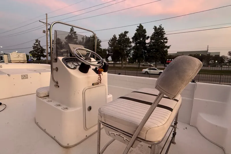 Slide: The Image of 2011 Carolina Skiff 218 DLV boat console and seating at sunset. - 11