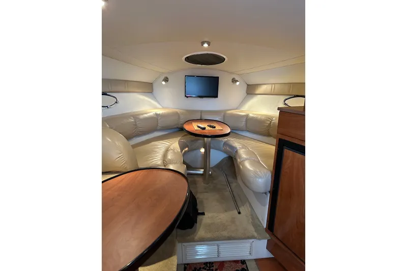 Slide: The Image of Interior of 2005 Larson Cabrio 310 boat with plush seating and mounted TV. - 4