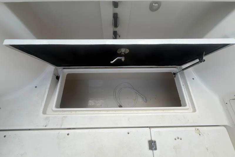 Slide: The Image of Open storage compartment on 2011 Robalo R305 Walkaround boat. - 15