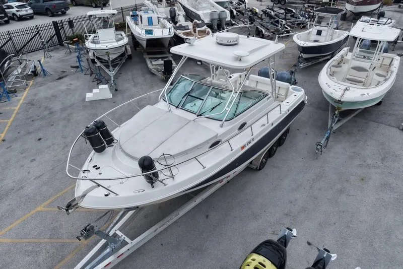 Slide: The Image of 2011 Robalo R305 Walkaround boat on trailer in marina lot. - 23
