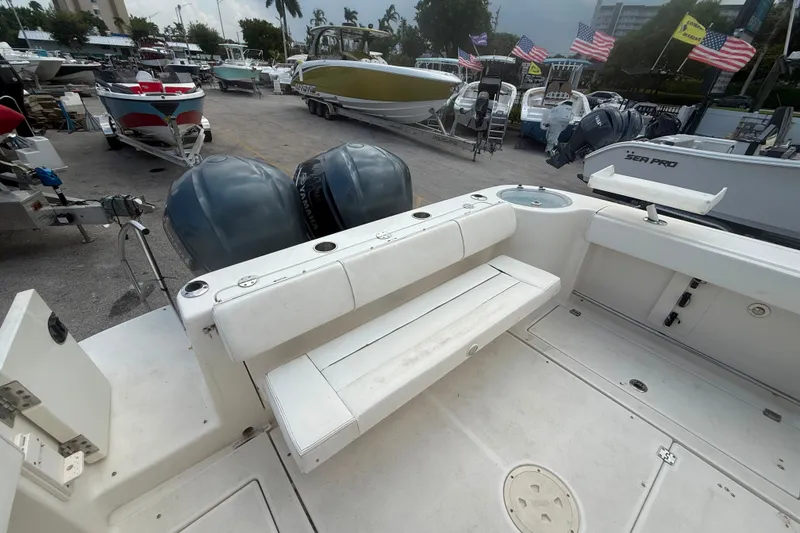 Slide: The Image of 2011 Robalo R305 Walkaround boat with dual engines, docked in a marina. - 24