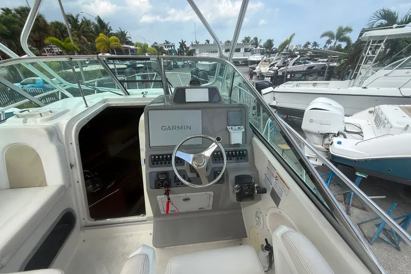 Slide: The Image of 2011 Robalo R305 Walkaround boat cockpit with Garmin navigation system and Yamaha engine. - 27