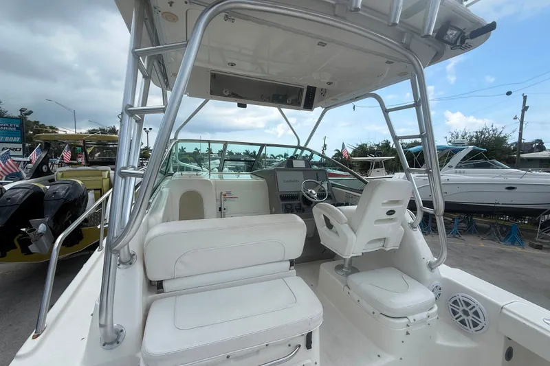 Slide: The Image of 2011 Robalo R305 Walkaround boat interior with helm, seating, and navigation equipment. - 31