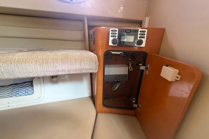 Slide: The Image of 2011 Robalo R305 Walkaround cabin interior with open cabinet and stereo system. - 40