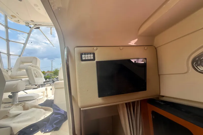 Slide: The Image of 2011 Robalo R305 Walkaround cabin interior with seating and control panel. - 45