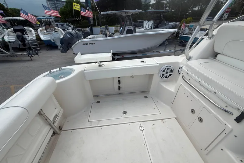 Slide: The Image of 2011 Robalo R305 Walkaround boat interior with seating and storage compartments. - 14