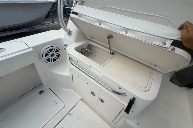 Slide: The Image of 2011 Robalo R305 Walkaround boat interior with storage compartment and speaker. - 25