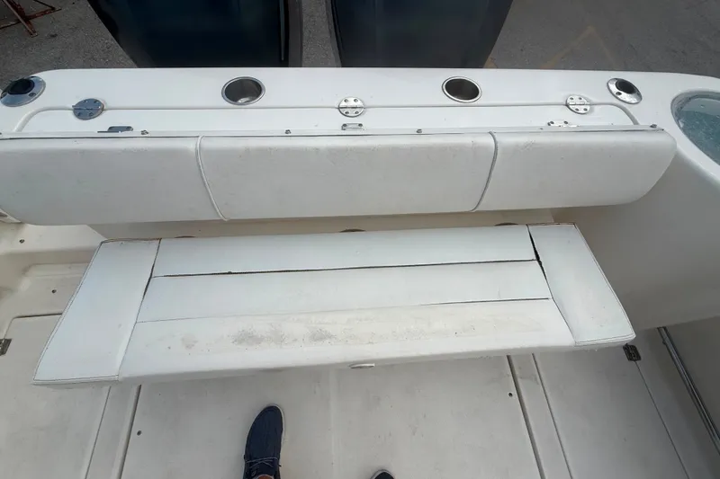 Slide: The Image of 2011 Robalo R305 Walkaround boat seating area with rod holders and storage. - 18