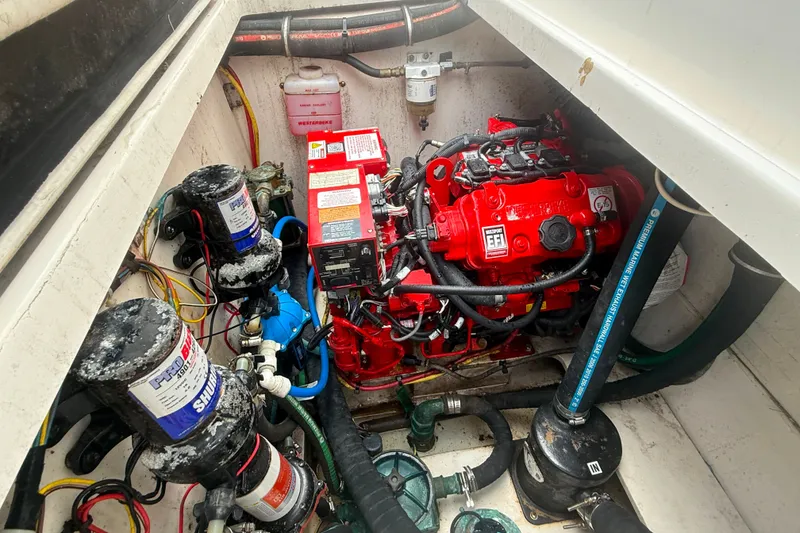 Slide: The Image of Engine compartment of 2011 Robalo R305 Walkaround with red EFI engine and marine components. - 48