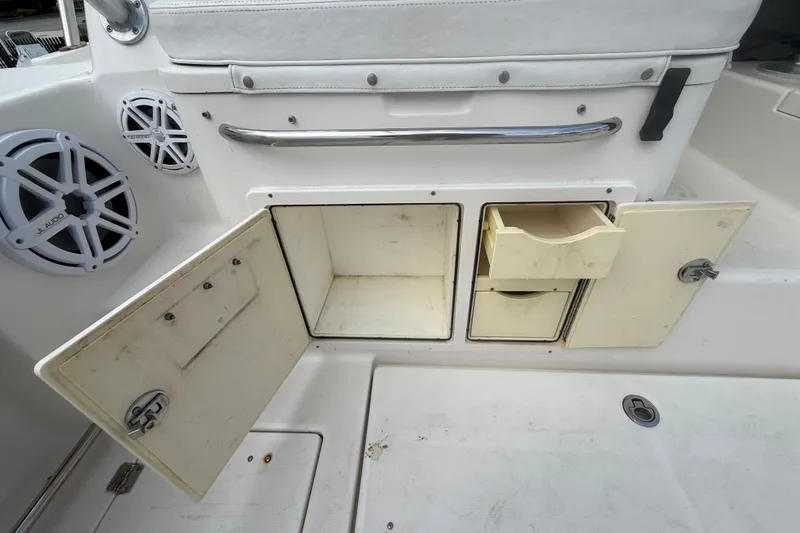 Slide: The Image of 2011 Robalo R305 Walkaround boat storage compartments and JL Audio speakers. - 28