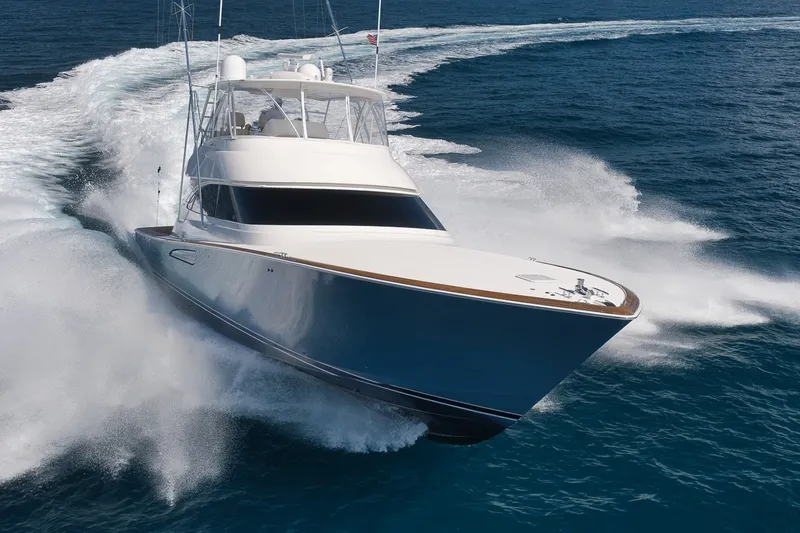 Slide: The Image of A 2017 Viking 62 Convertible speeds across the sea, spraying water on both sides. - 12