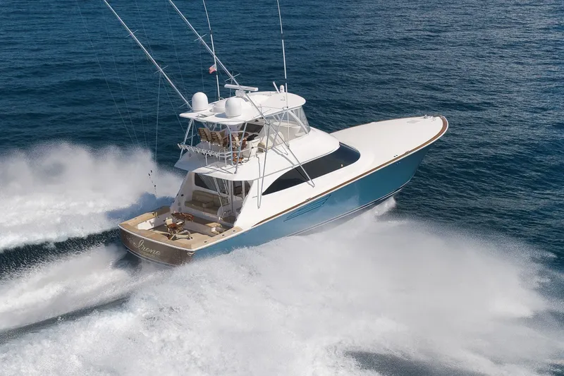 Slide: The Image of A 2017 Viking 62 Convertible speeding across the water, featuring a blue hull. - 14