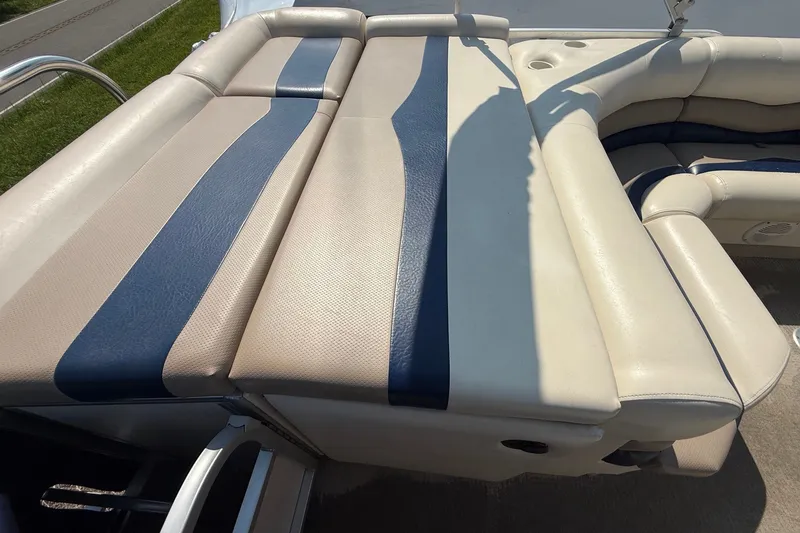 Slide: The Image of 2006 Triton Summit Pontoon 220 T Platinum boat seating, featuring beige and blue upholstery. - 16
