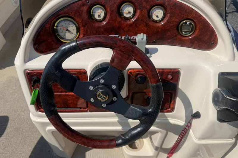 Slide: The Image of Steering wheel and dashboard of 2006 Triton Summit Pontoon 220 T Platinum boat. - 21
