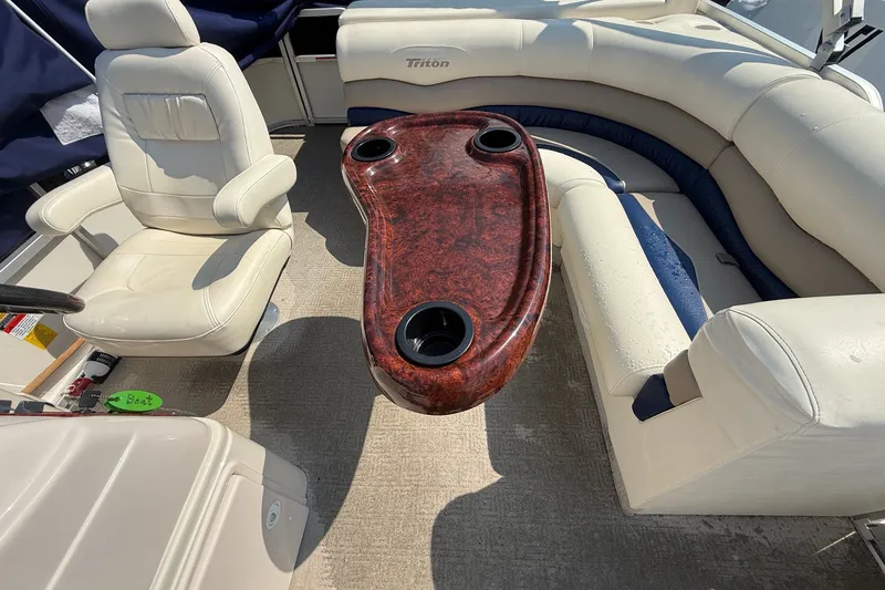 Slide: The Image of Interior of 2006 Triton Summit Pontoon 220 T Platinum with seating and table. - 13
