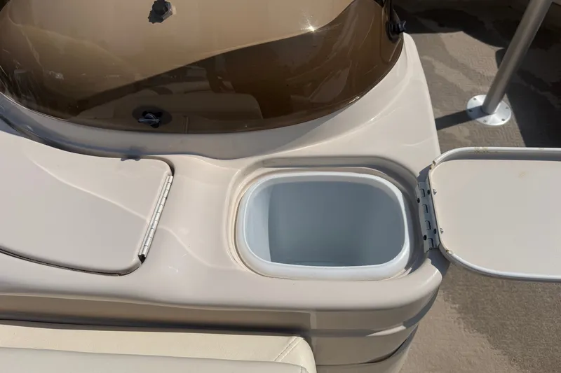 Slide: The Image of Open storage compartment on 2006 Triton Summit Pontoon 220 T Platinum boat. - 24