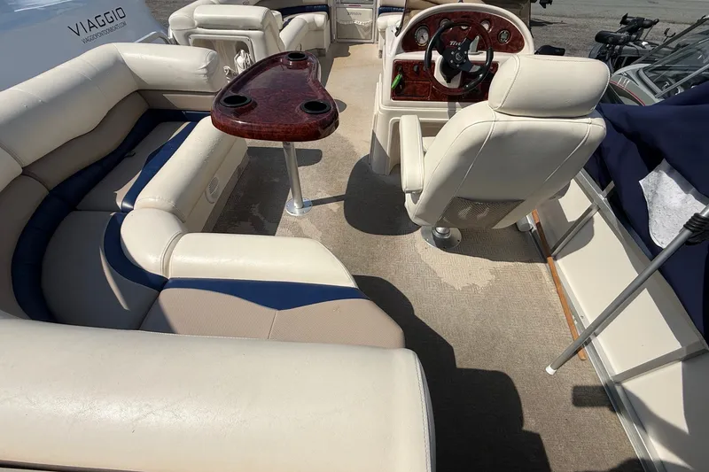 Slide: The Image of Interior of 2006 Triton Summit Pontoon 220 T Platinum with seating and steering console. - 20