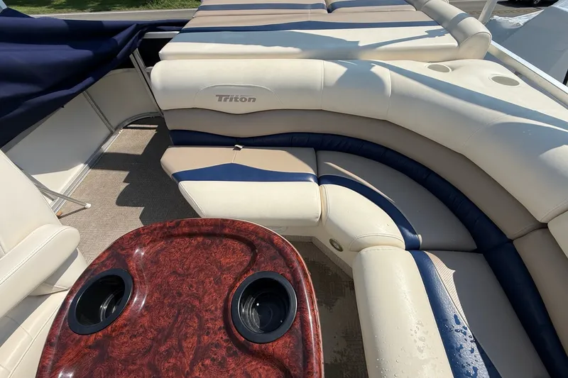 Slide: The Image of Luxurious seating on 2006 Triton Summit Pontoon 220 T Platinum with woodgrain table and cup holders. - 12