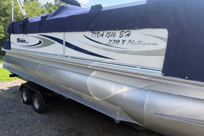 The Image of 2006 Triton Summit Pontoon 220 T Platinum with cover on trailer. - 1