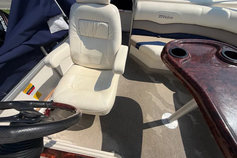 Slide: The Image of 2006 Triton Summit Pontoon 220 T Platinum interior with steering wheel and seating. - 14