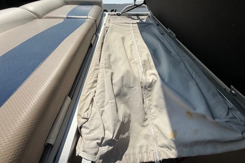 Slide: The Image of 2006 Triton Summit Pontoon 220 T Platinum interior with beige and blue seating. - 18