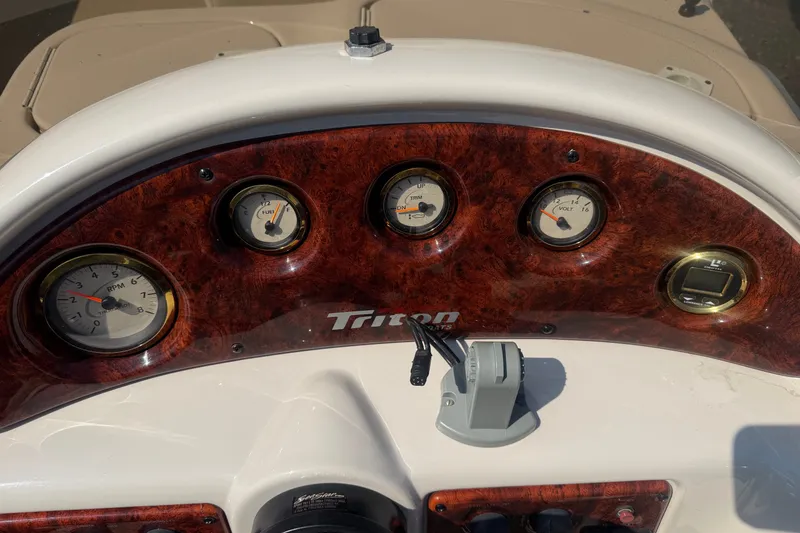 Slide: The Image of Dashboard of 2006 Triton Summit Pontoon 220 T Platinum with gauges and controls. - 23