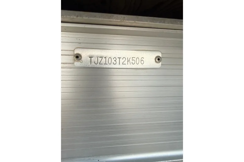 Slide: The Image of 2006 Triton Summit Pontoon 220 T Platinum serial number plate on metallic surface. - 31