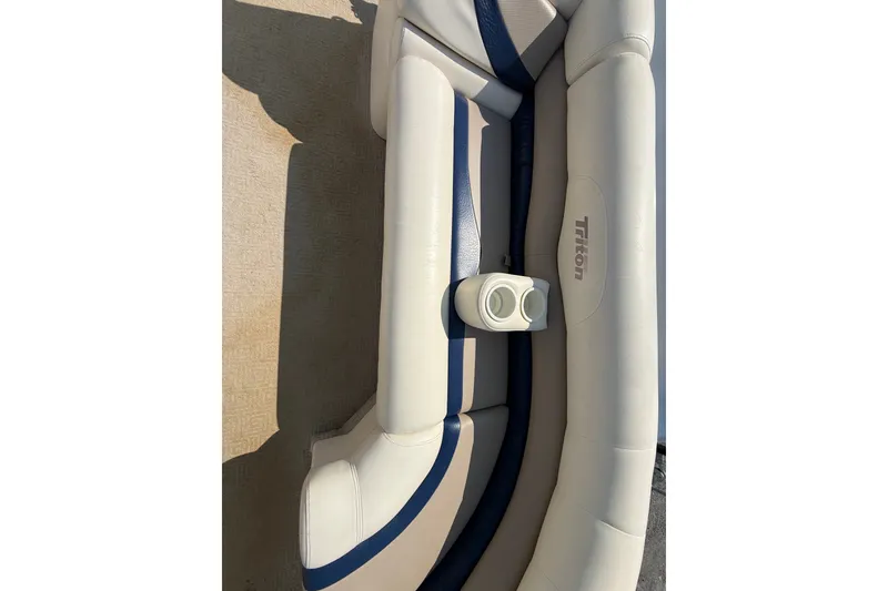 Slide: The Image of 2006 Triton Summit Pontoon 220 T Platinum boat seating with cup holder, beige and blue upholstery. - 7