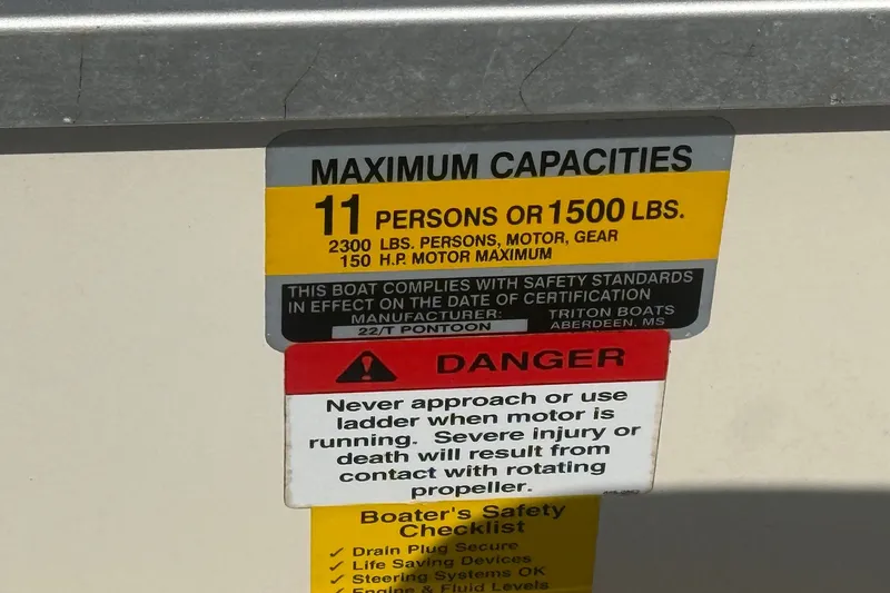 Slide: The Image of 2006 Triton Summit Pontoon 220 T Platinum capacity label: 11 persons or 1500 lbs, safety warnings. - 22