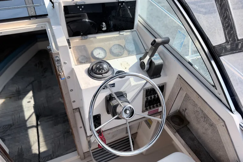 Slide: The Image of 1993 Grady-White Seafarer 22 boat cockpit with steering wheel and controls. - 7