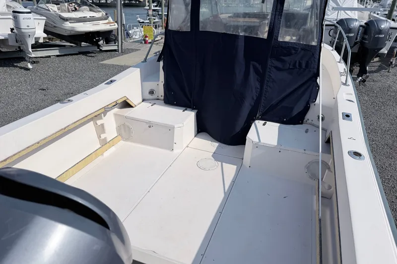 Slide: The Image of 1993 Grady-White Seafarer 22 boat interior with seating and canopy, docked at marina. - 5