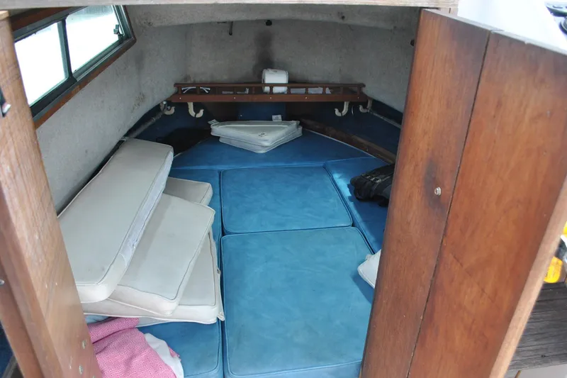 Slide: The Image of Interior cabin of 1988 Grady-White Overnighter 20 boat with blue cushions. - 7